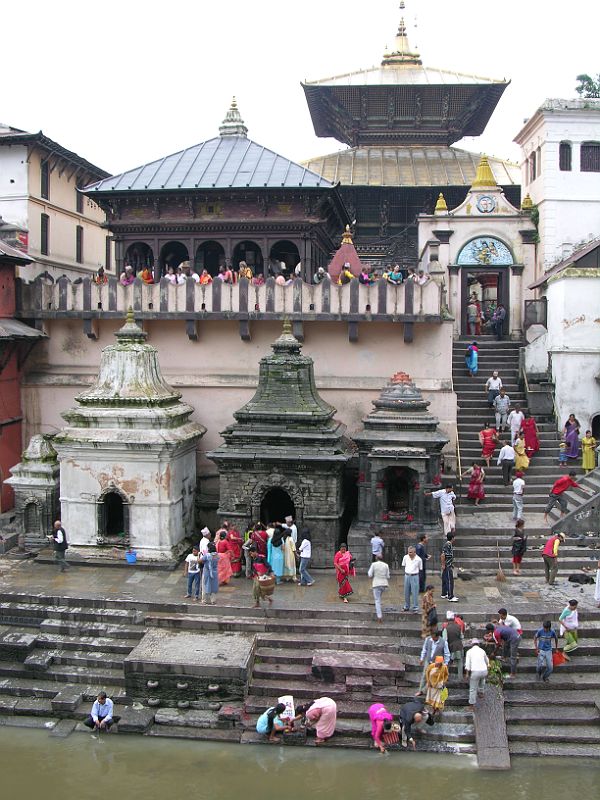 Kathmandu Pashupatinath 01 Pashupatinath Temple From Across Bagmati River The Pashupatinath Temple complex in Kathmandu on the banks of the holy Bagmati River is Nepal�s most important Hindu temple, and probably the holiest Hindu site outside India. Pashupati is one of the many names of Shiva, the most revered god in the Hindu pantheon, this one meaning the Lord of the Animals. Supposedly Shiva needed a holiday from Mount Kailash and chose the Kathmandu valley. Non-Hindus are not allowed to enter the temple. Below the Pashupatinath temple runs the Bagmati River, a holy river that eventually joins the Ganges. Pilgrims throw the holy water onto themselves, while a few hearty Hindus bathe fully.